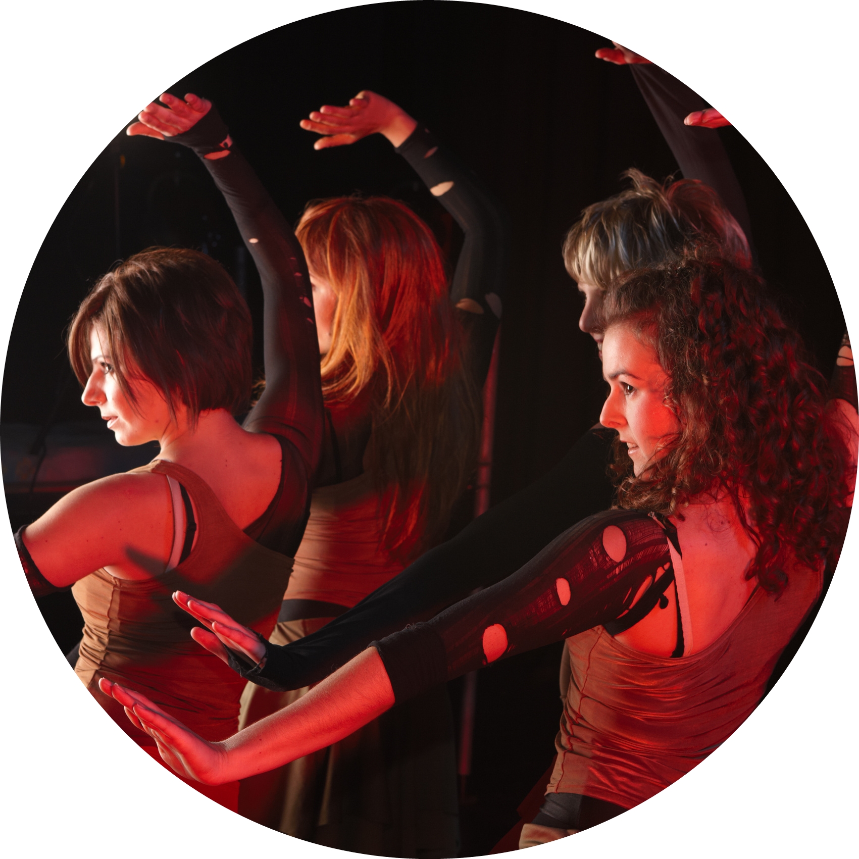 A group of sexy young freestyle dancers on a dark stage with red and blue stage lights